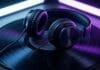 headphones on vintage vinyl record with purple neon glow